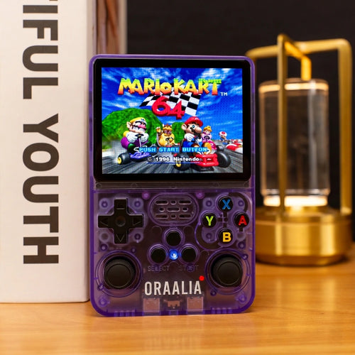 Console de jeux rétro ORAALIA RETRO violette translucide posée sur un bureau