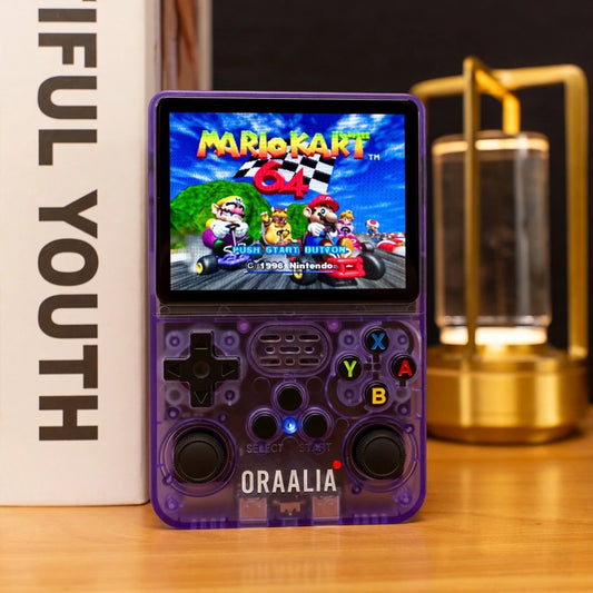 Console de jeux rétro ORAALIA RETRO violette translucide posée sur un bureau